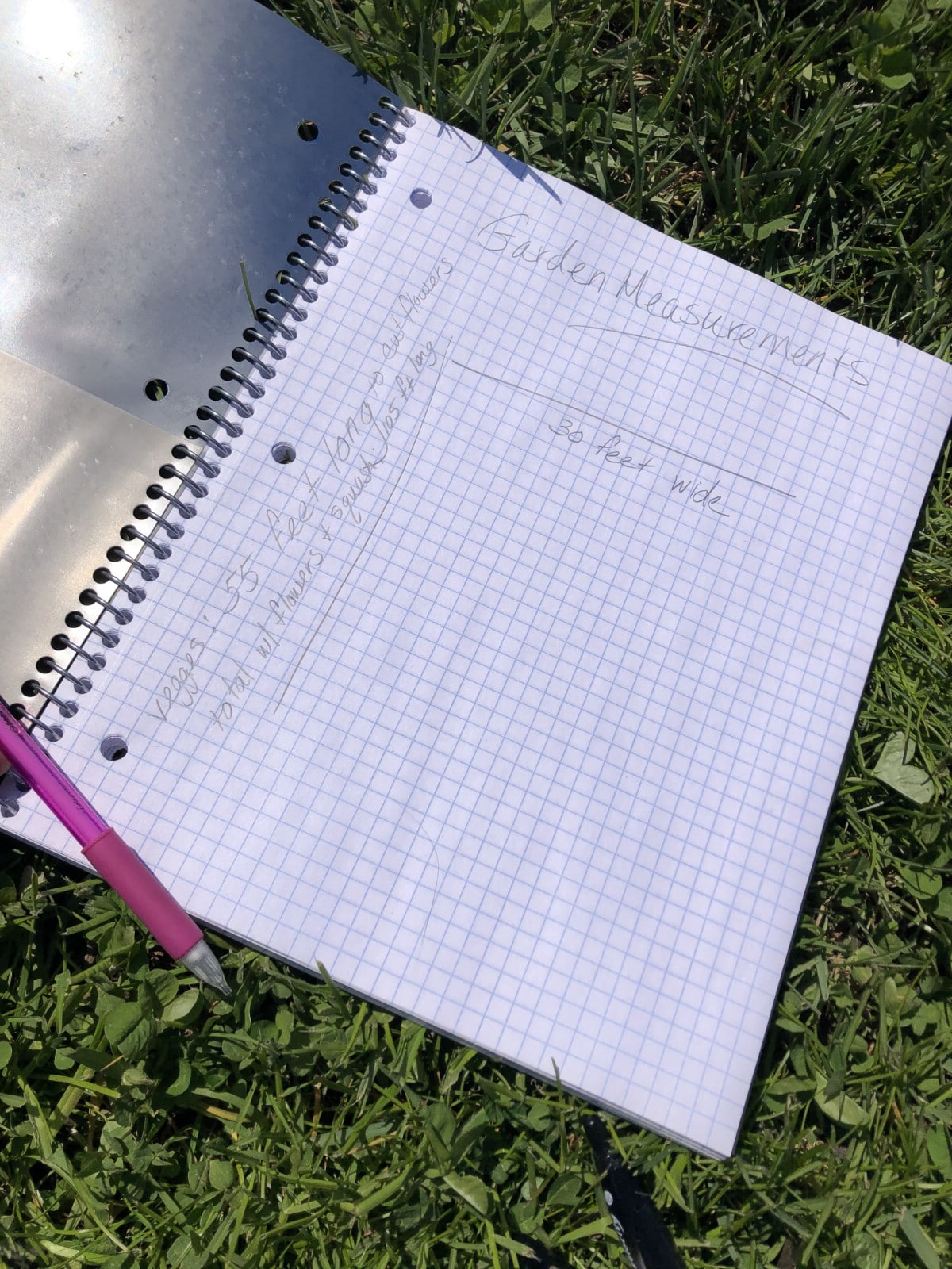 garden journal on grass with pencil