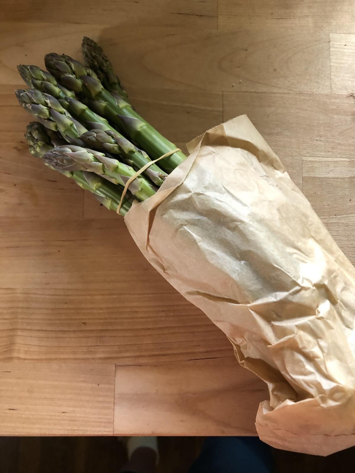 asparagus bundled in brown bag