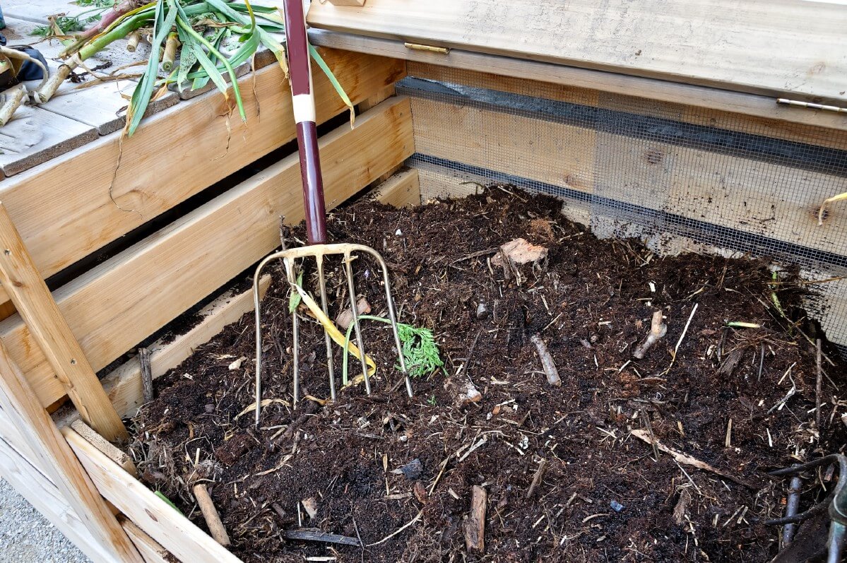 pitchfork in compost in compost bin