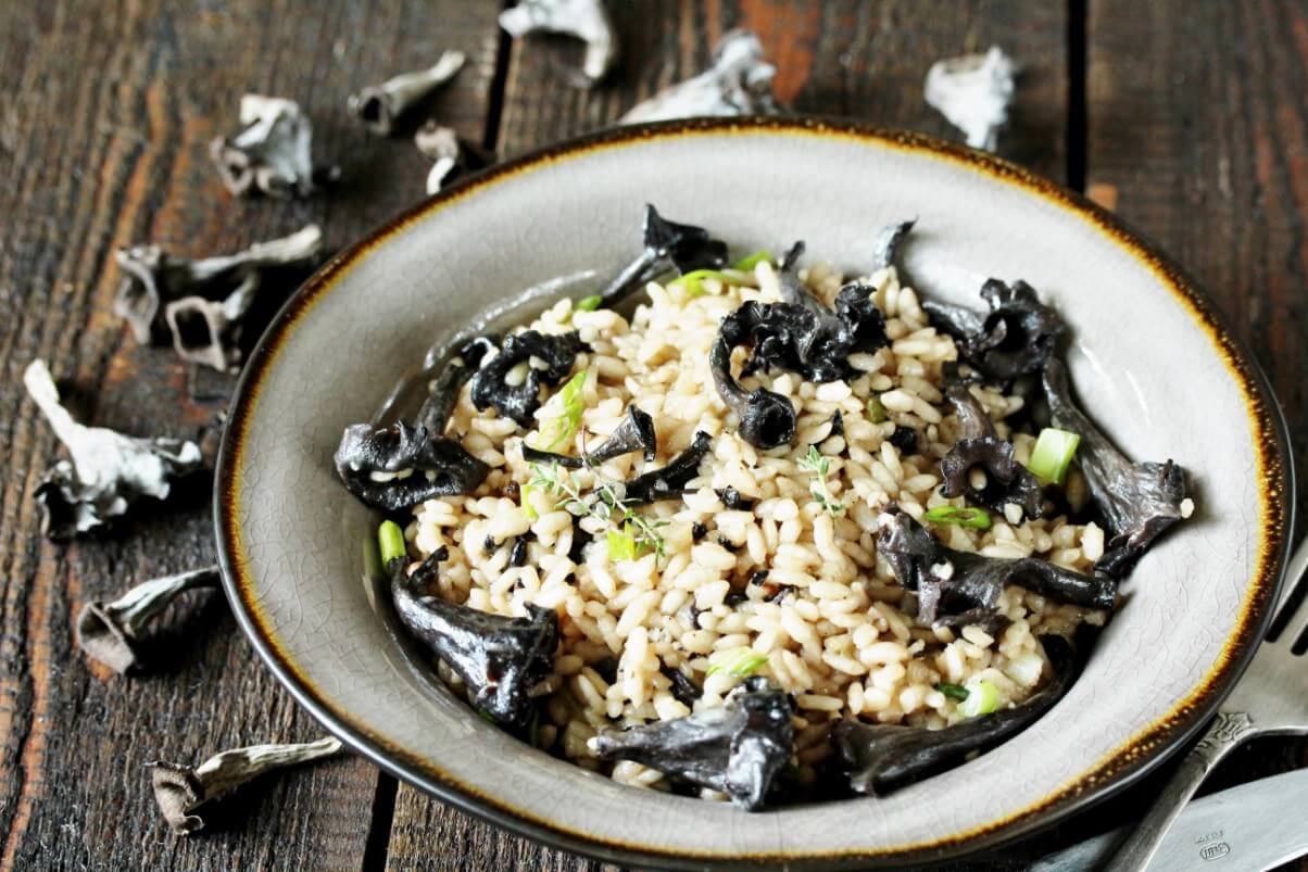 A dish of cooked rice with black trumpets