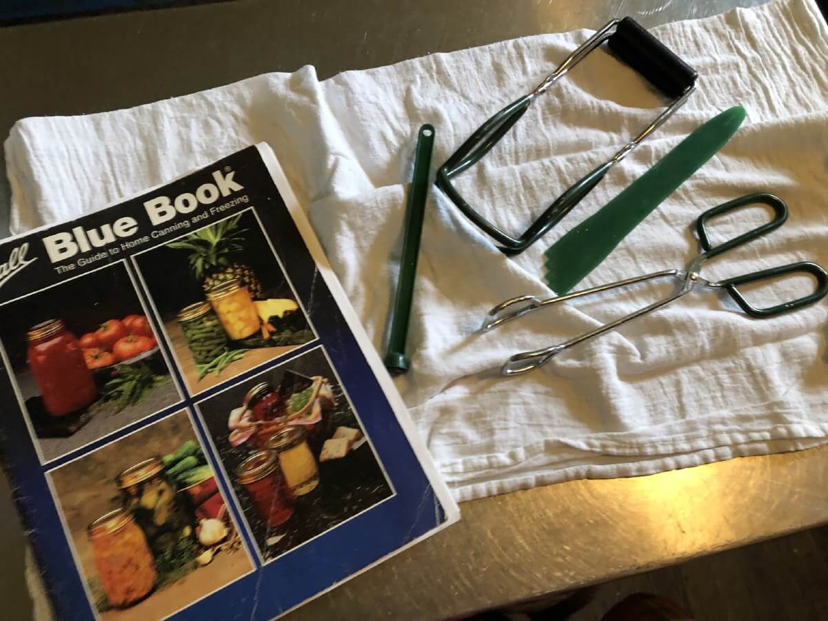 canning utensils and Ball Blue Book