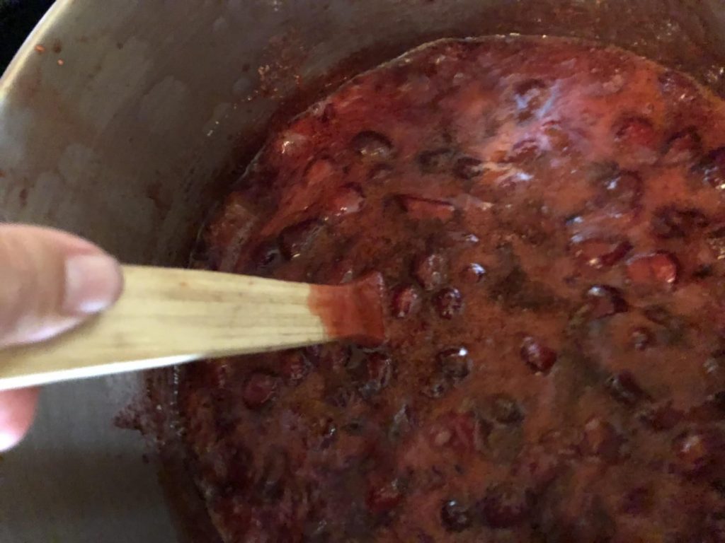 stirring jam at rolling boil