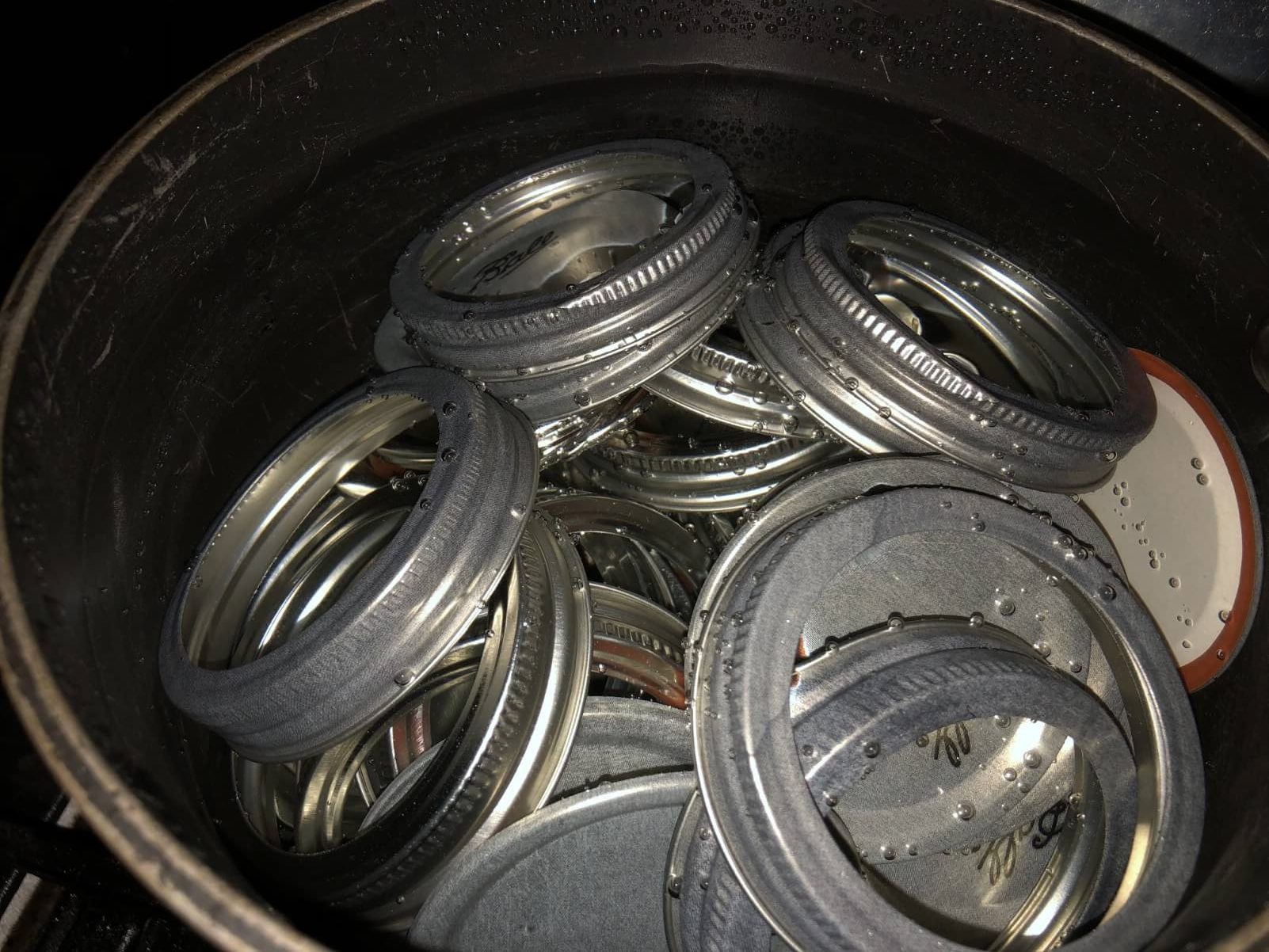 two piece canning lids in water to sterilize
