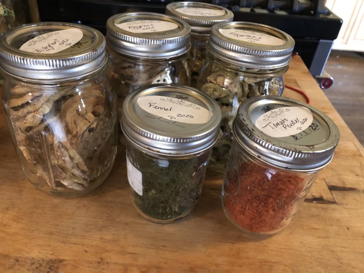 six cans of dried garden vegetables