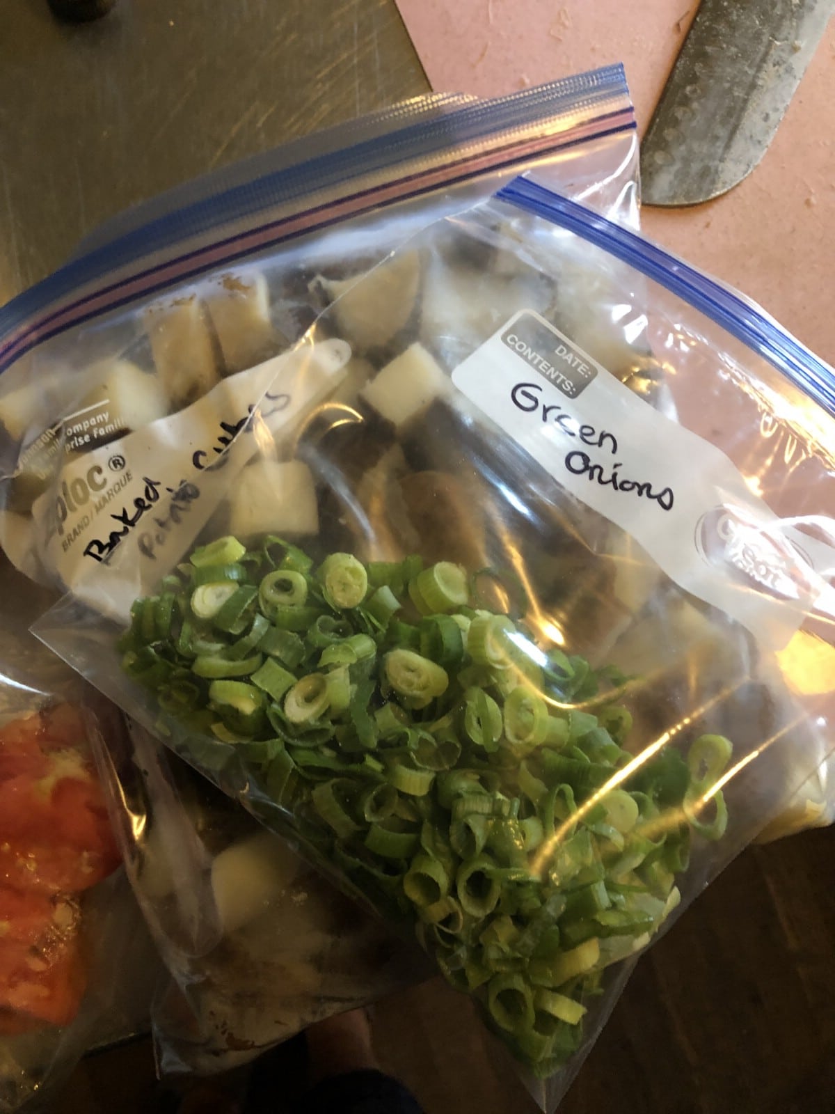 green onions and potatoes bagged in zipper bags for freezing
