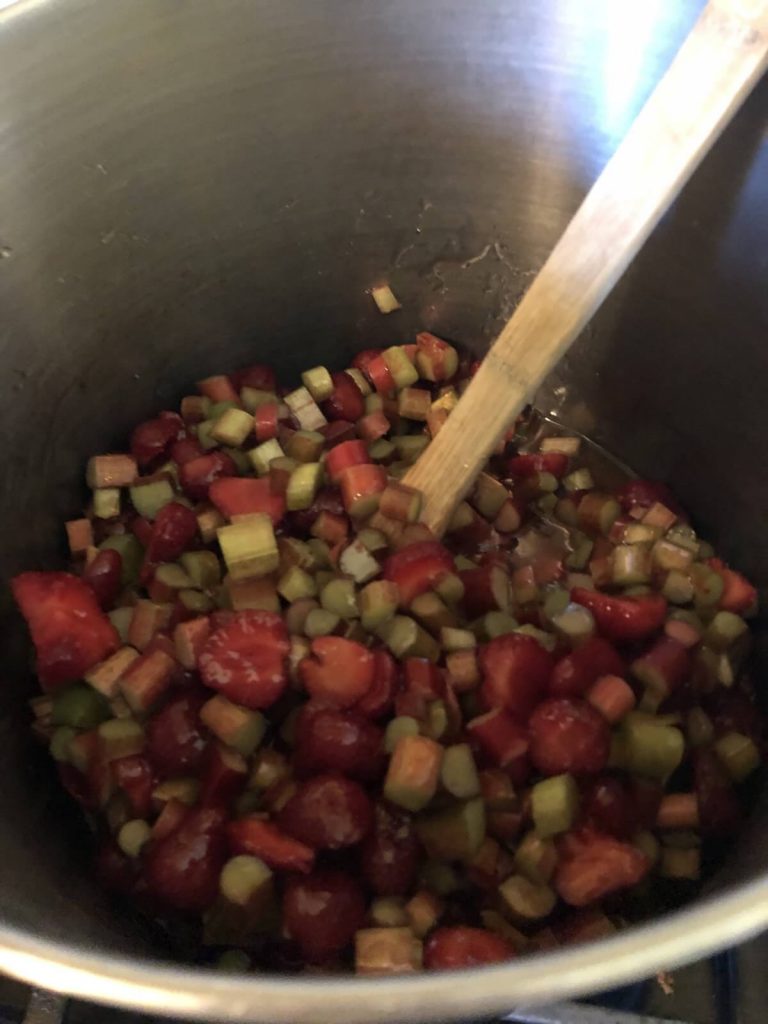 strawberries and rhubarb being cooked for fruit puree for fruit leather