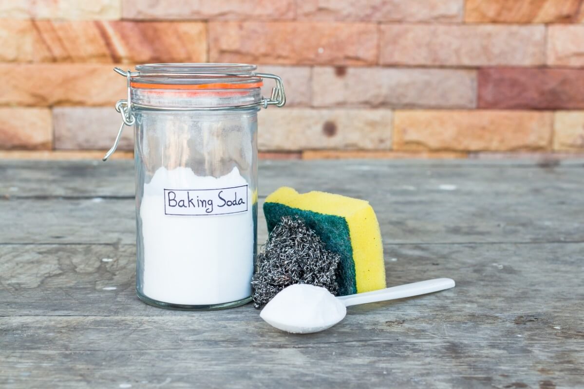 baking soda next to a scrubber and steel wool