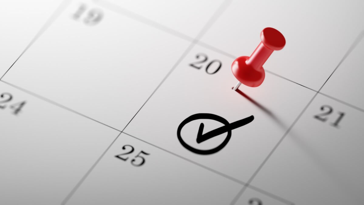 circled checkmark on a calendar date with a red pushpin