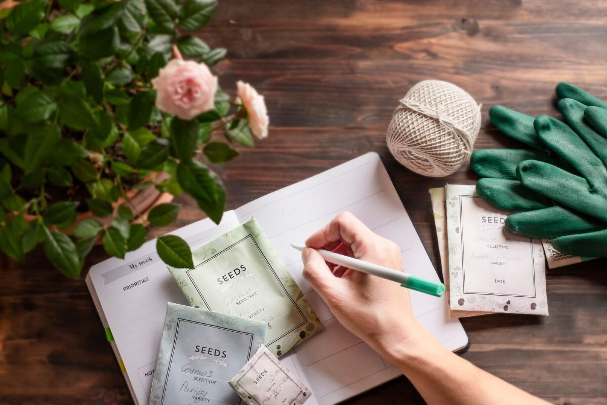 gardener entering planting and seed-starting dates into a calendar