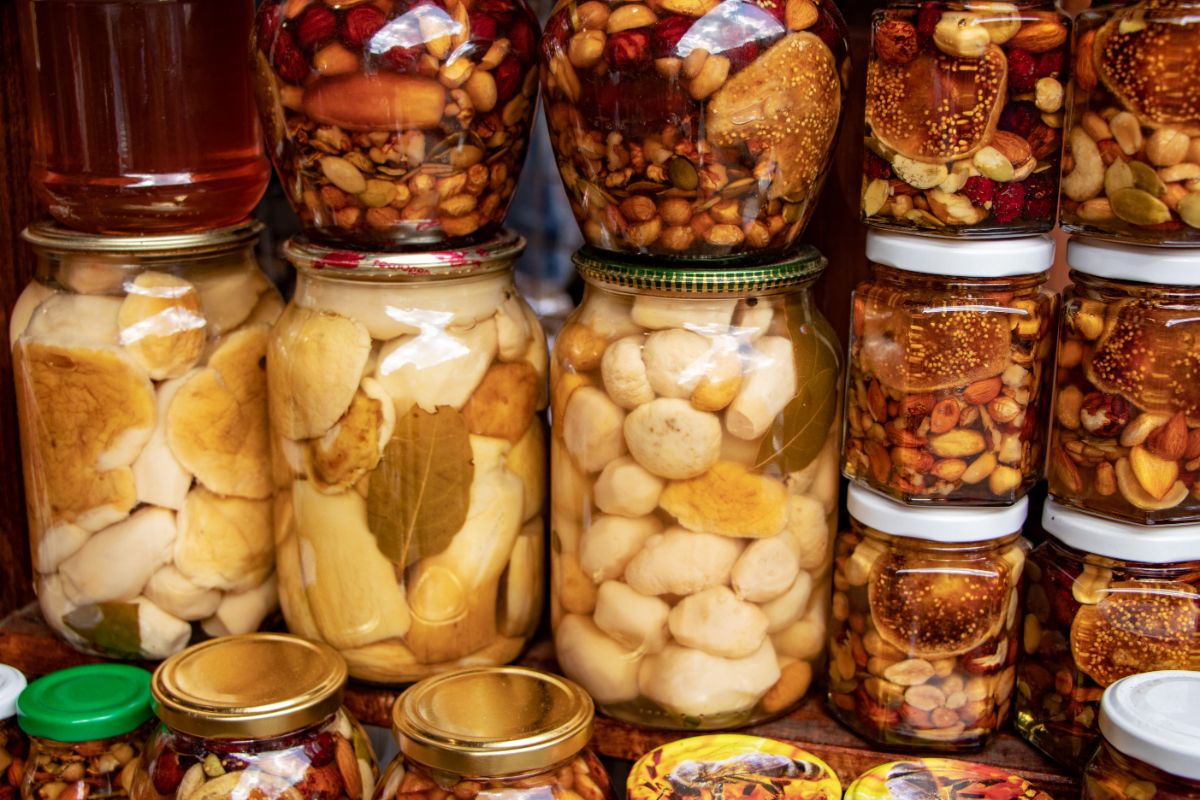 a collection of canned goods on a pantry shelf