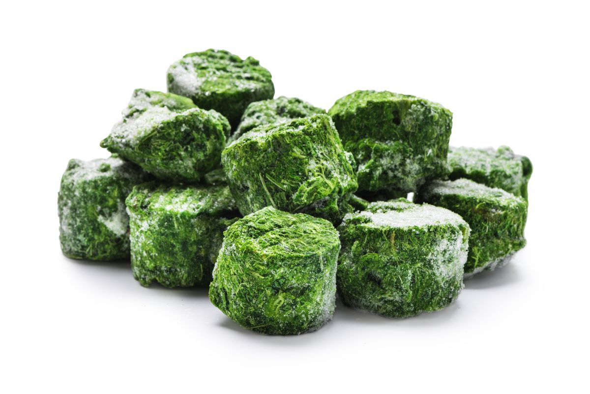 Cubes of spinach frozen in muffin trays for future use.