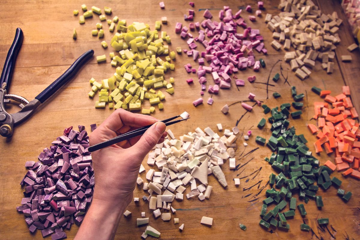 Various mosaic pieces organized into piles by color