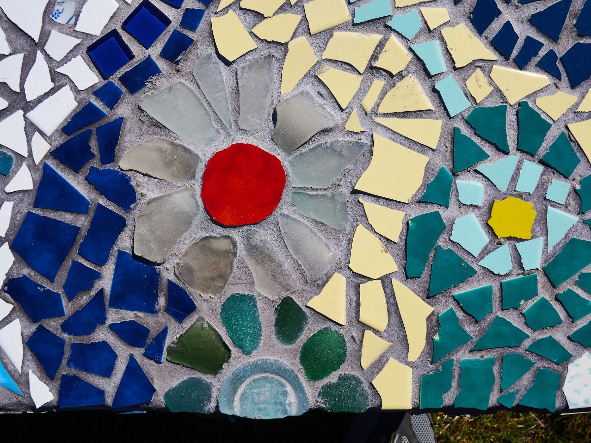 A closeup of a completed DIY mosaic garden stepping stone