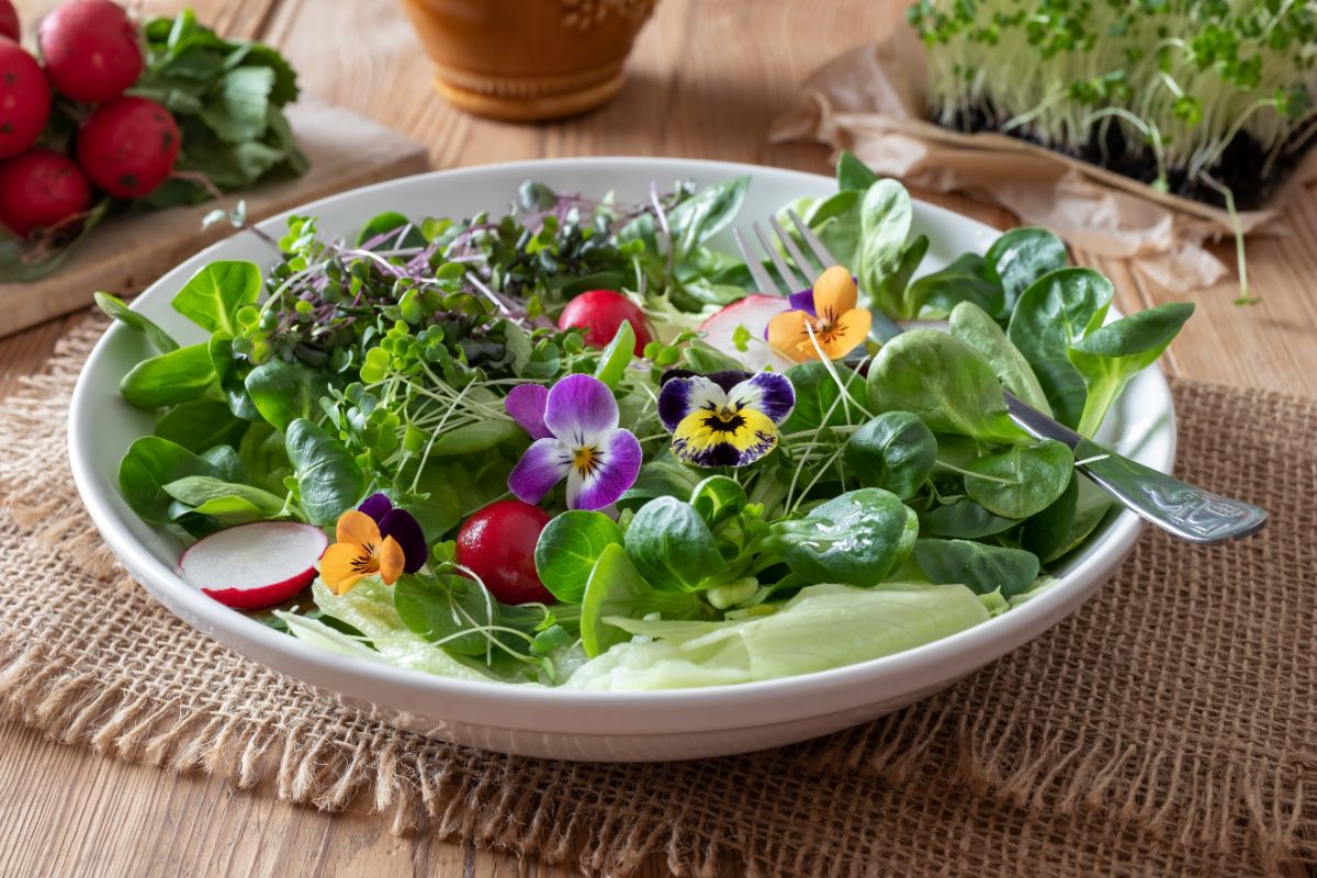 A salad topped with cheerful edible pansies