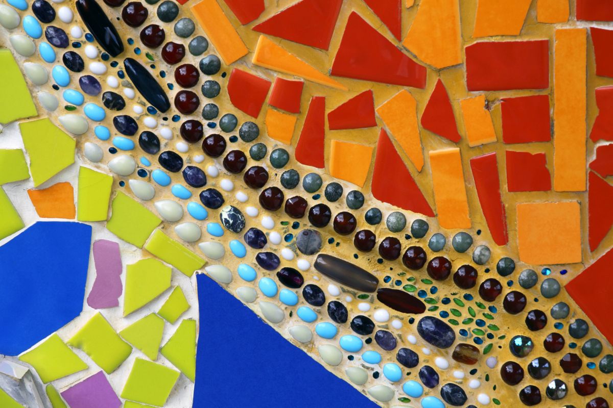A mosaic stepping stone section created with a mix of glass tiles and beads