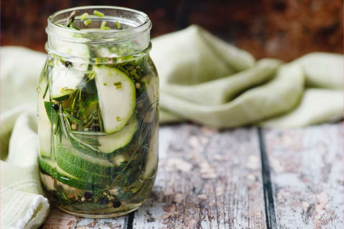 Zucchini pickled in a jar with spices and herbs