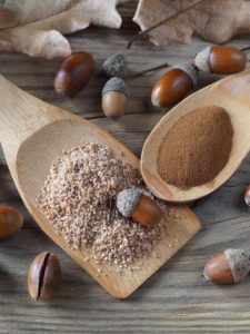 Image of acorns hanging on a branch and an image of acorn flour on wooden spatulas.