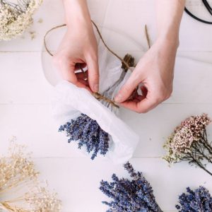 A florist making a lavender dried bouquet.