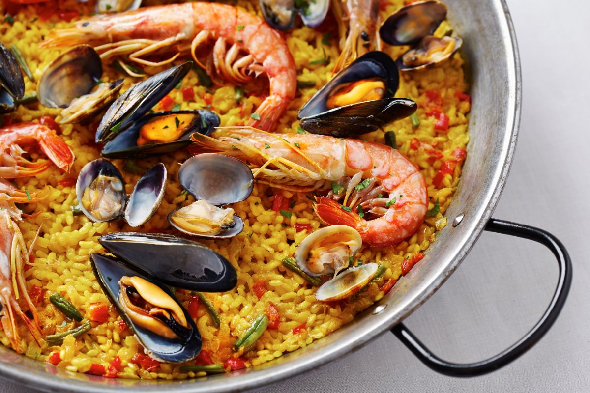 A rice and seafood dish is prepared with saffron