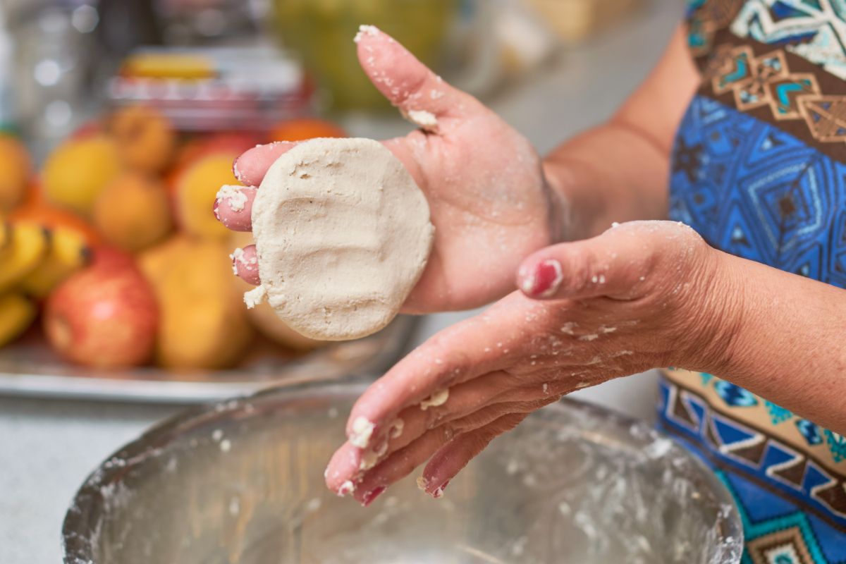 A woman forms tortillas made from homemade dried ground corn