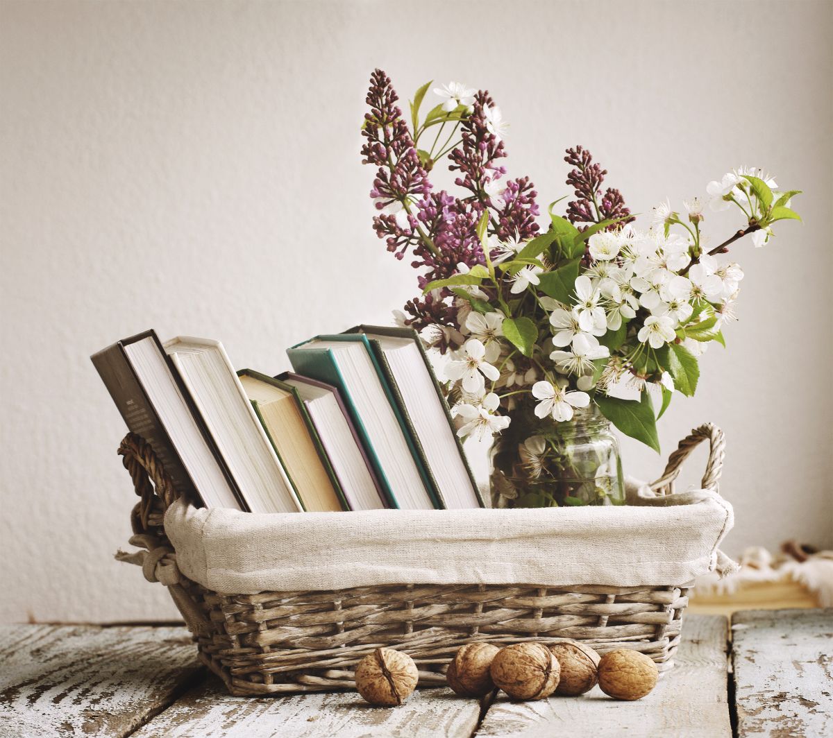 A basket with gardening books and natural plants