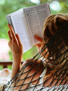 Image of woman reading a book and image of books in a basket.