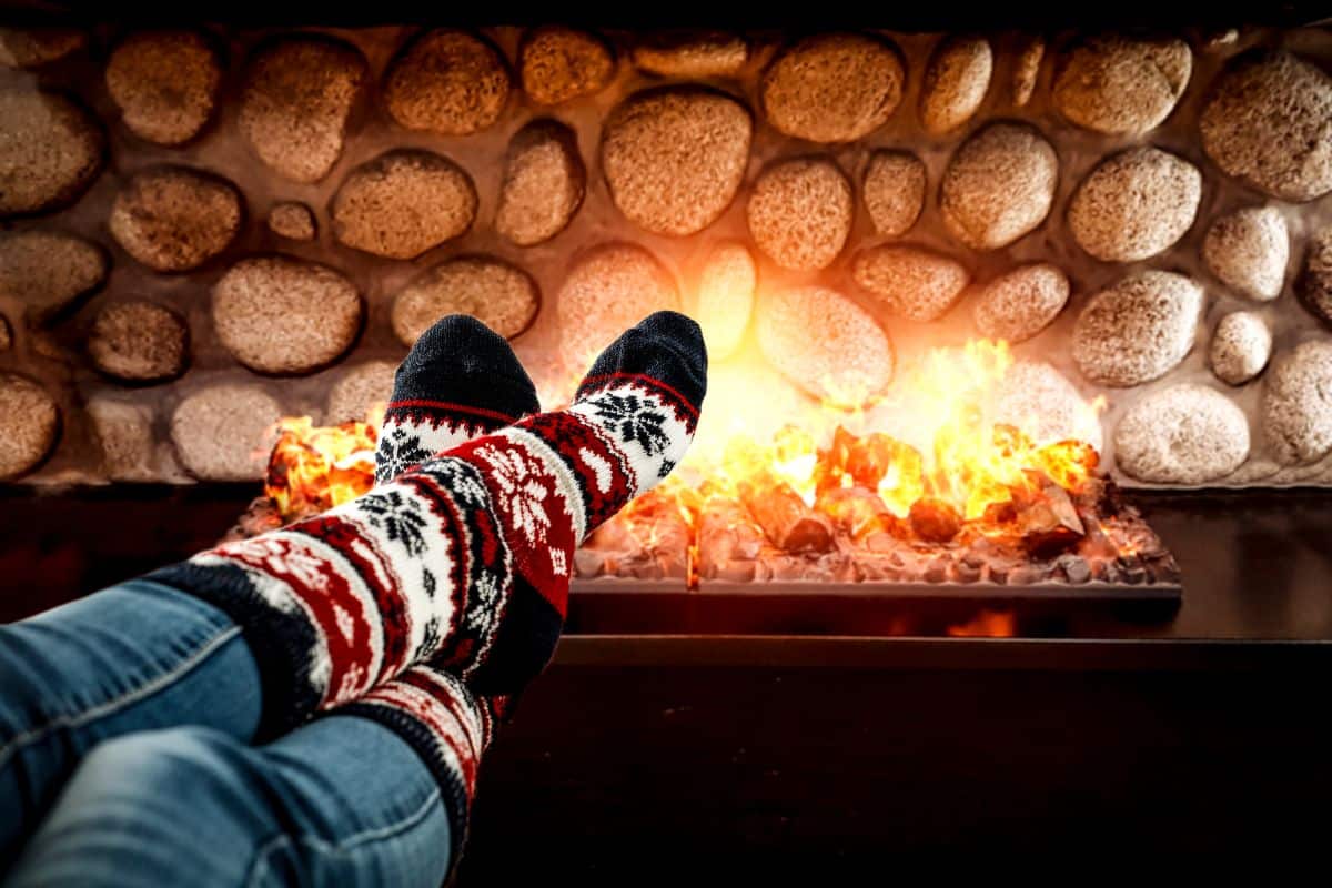 An off-season gardener enjoying sitting by a warm fire