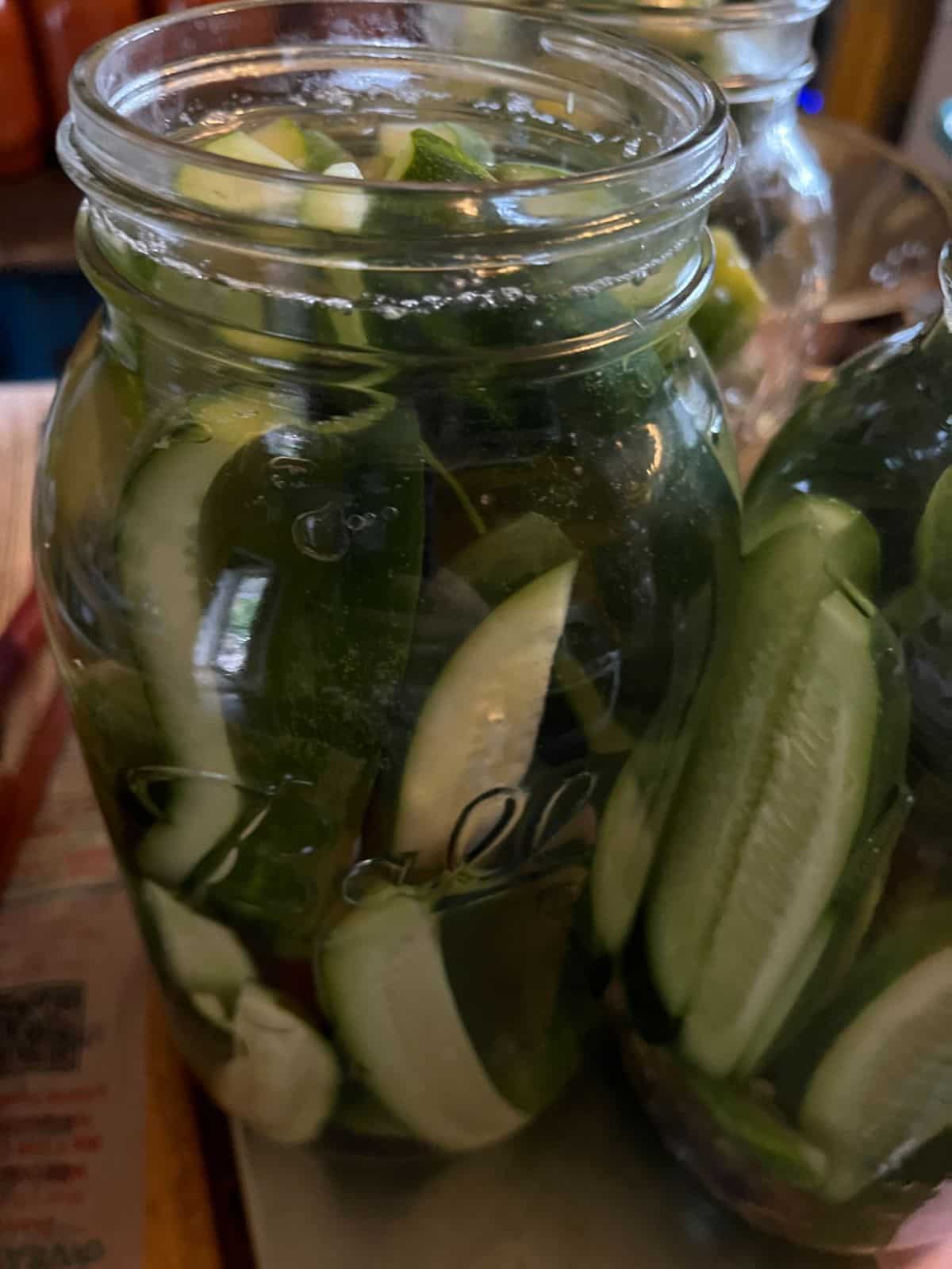 A jar of prepared refrigerator dill pickles close up