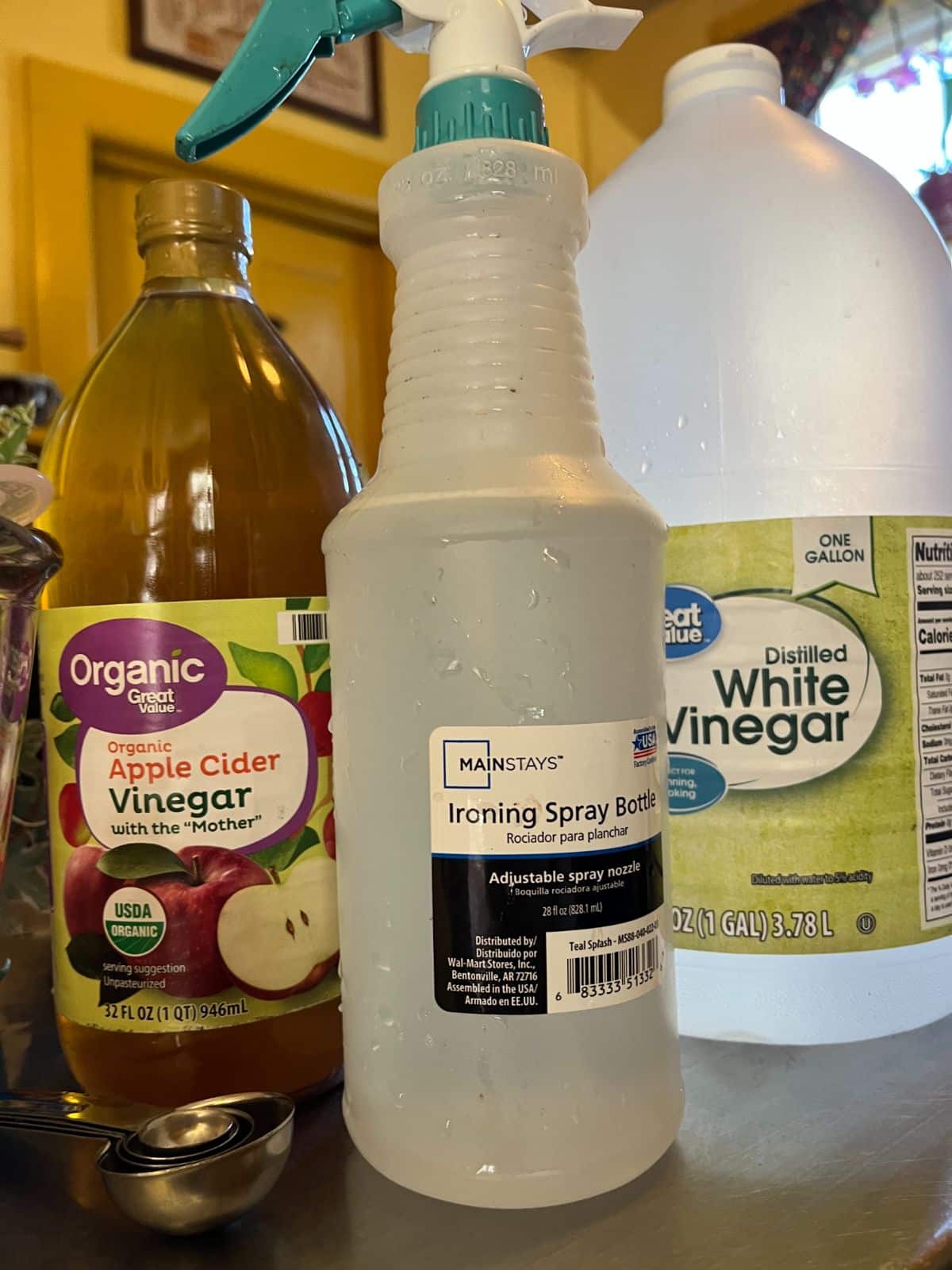 A spray bottle and vinegar for making a DIY vinegar spray