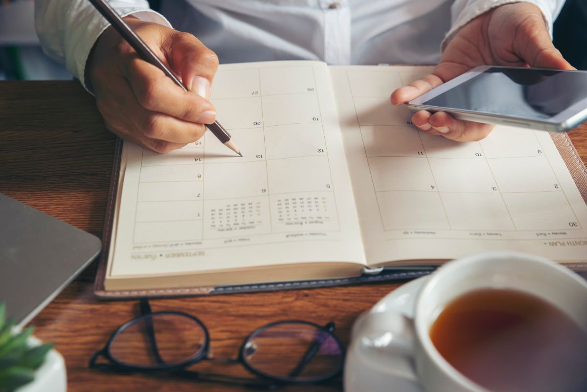 A gardener with a calendar planning when to order seeds