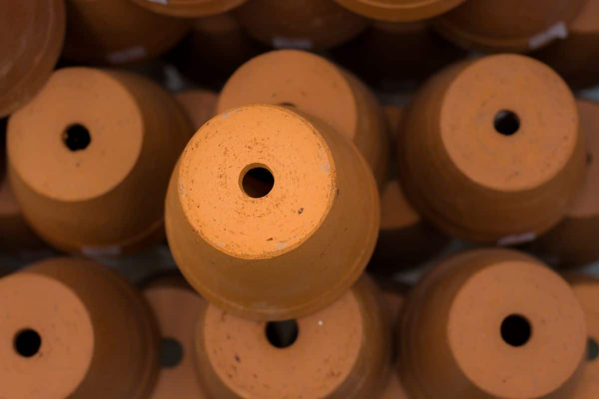 Covering drain holes stops gnats from infesting soil from the bottom up.