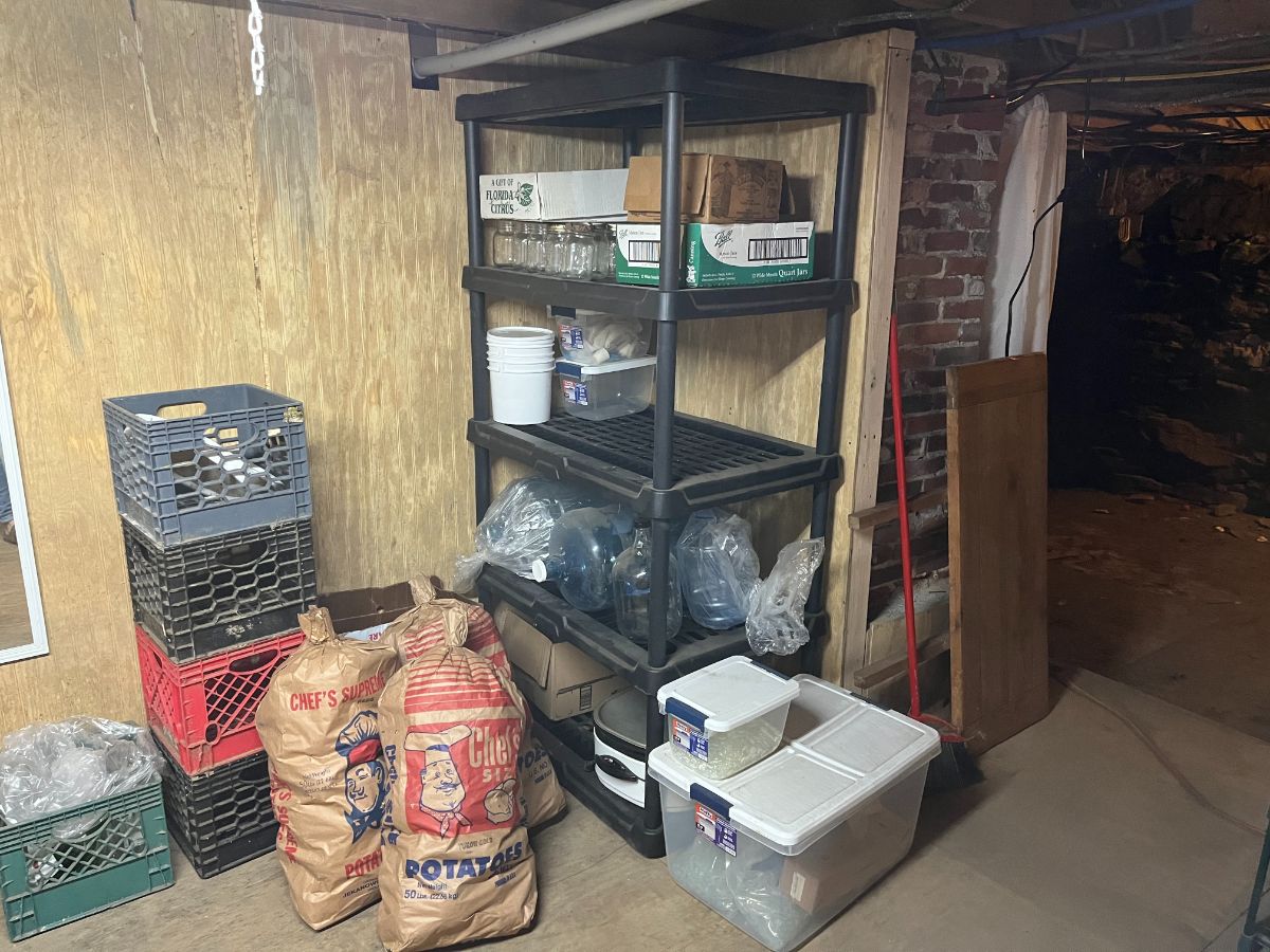 A well-organized cold storage room using a variety of crates, containers, and packaging materials