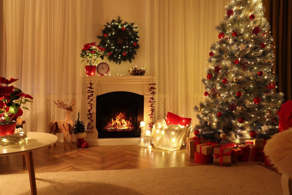 A nice Christmas scene with a poinsettia on a fireplace mantel.