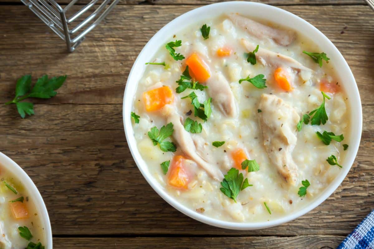 Fresh carrots and carrot tops used in a soup