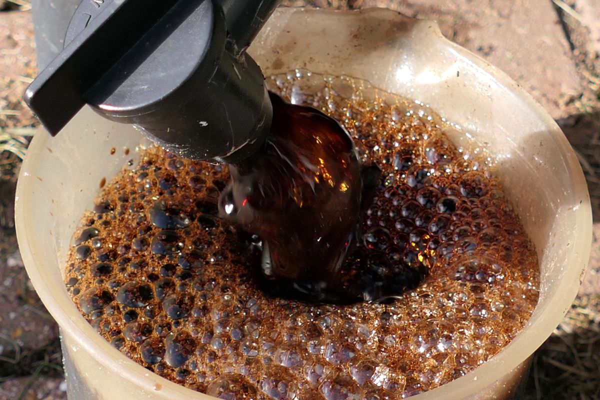 Compost tea runs out of a spigot