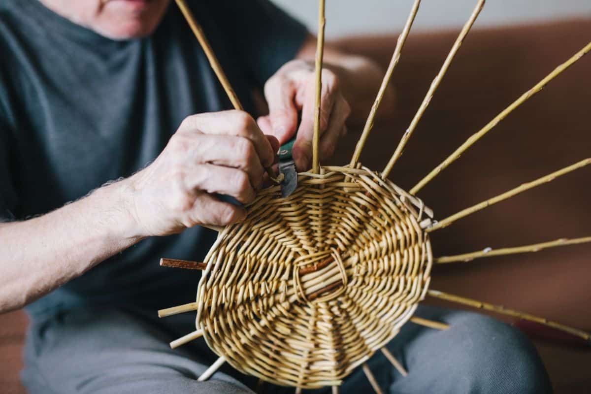 A crafter making a garden basket for use next summer