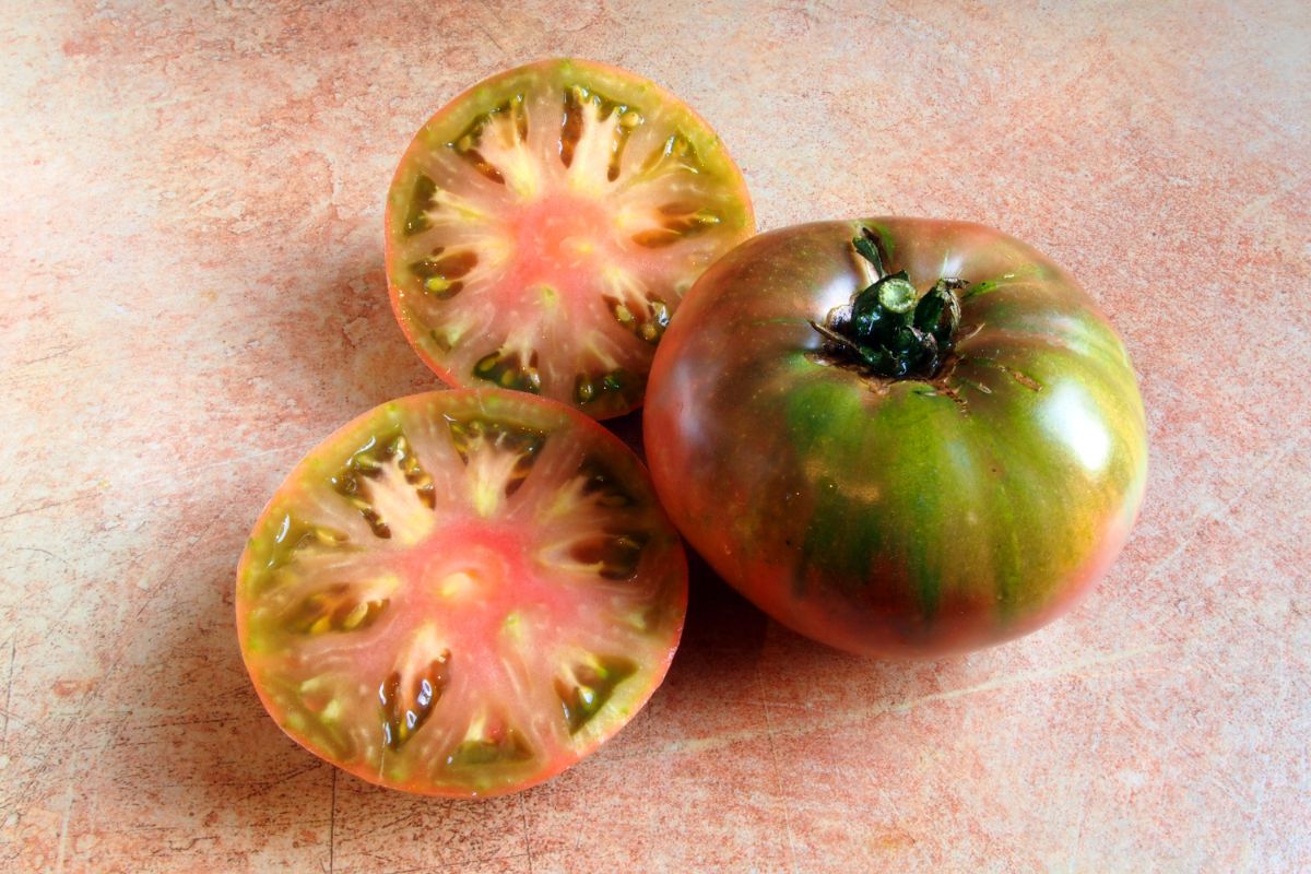 Sliced Cherokee Purple tomatoes showing meaty interior.