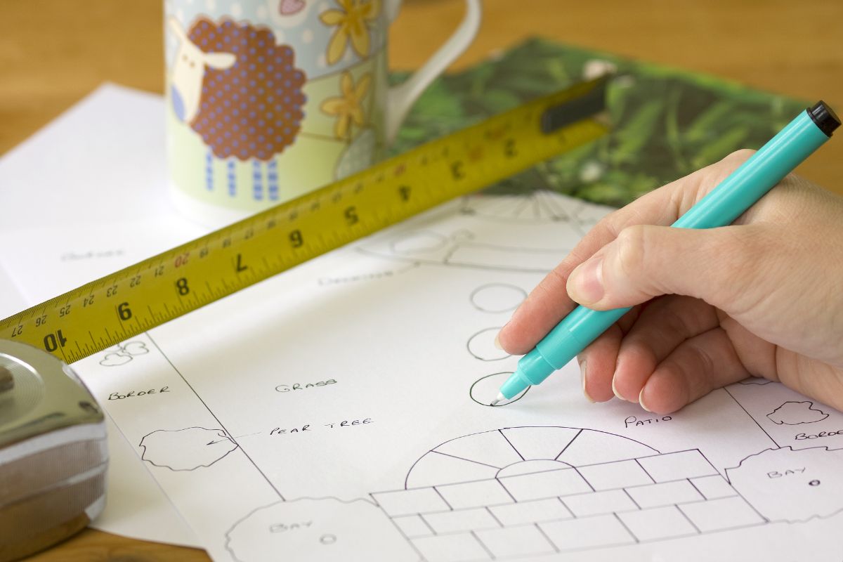A gardener sketches out plans for a square foot garden
