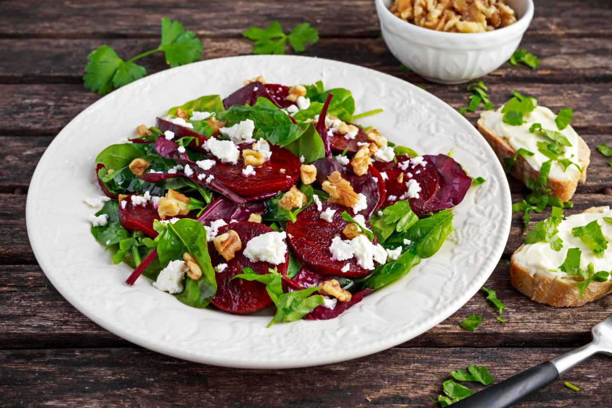 Sliced beets on a fresh salad with arugula