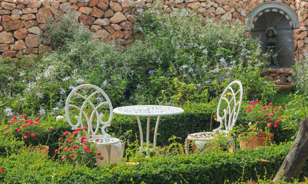 A cast iron table in a classic cottage garden