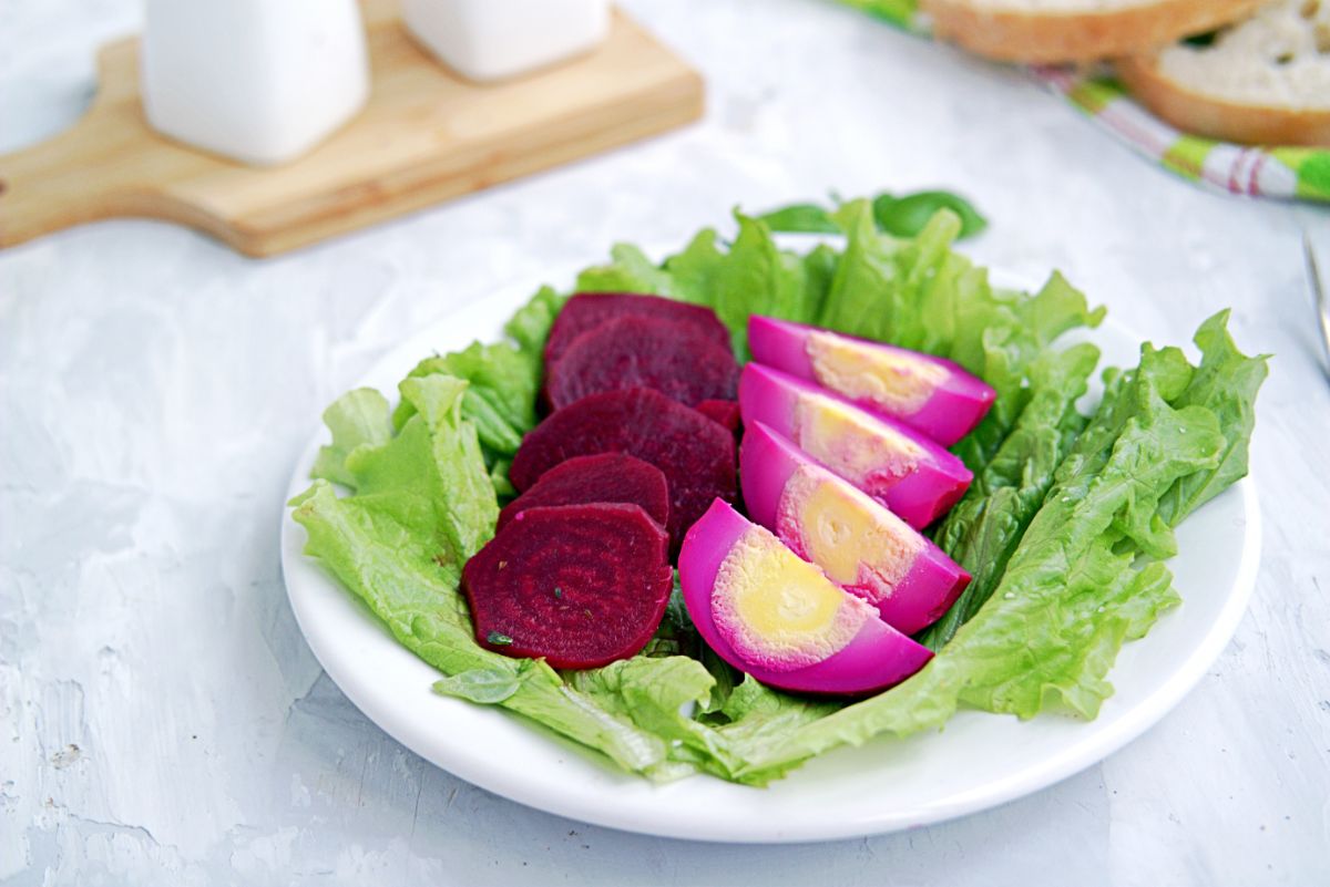 Pickled beets alongside purple-red pickled eggs