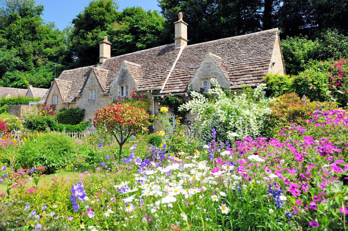 A cottage surrounded by a classic cottage garden