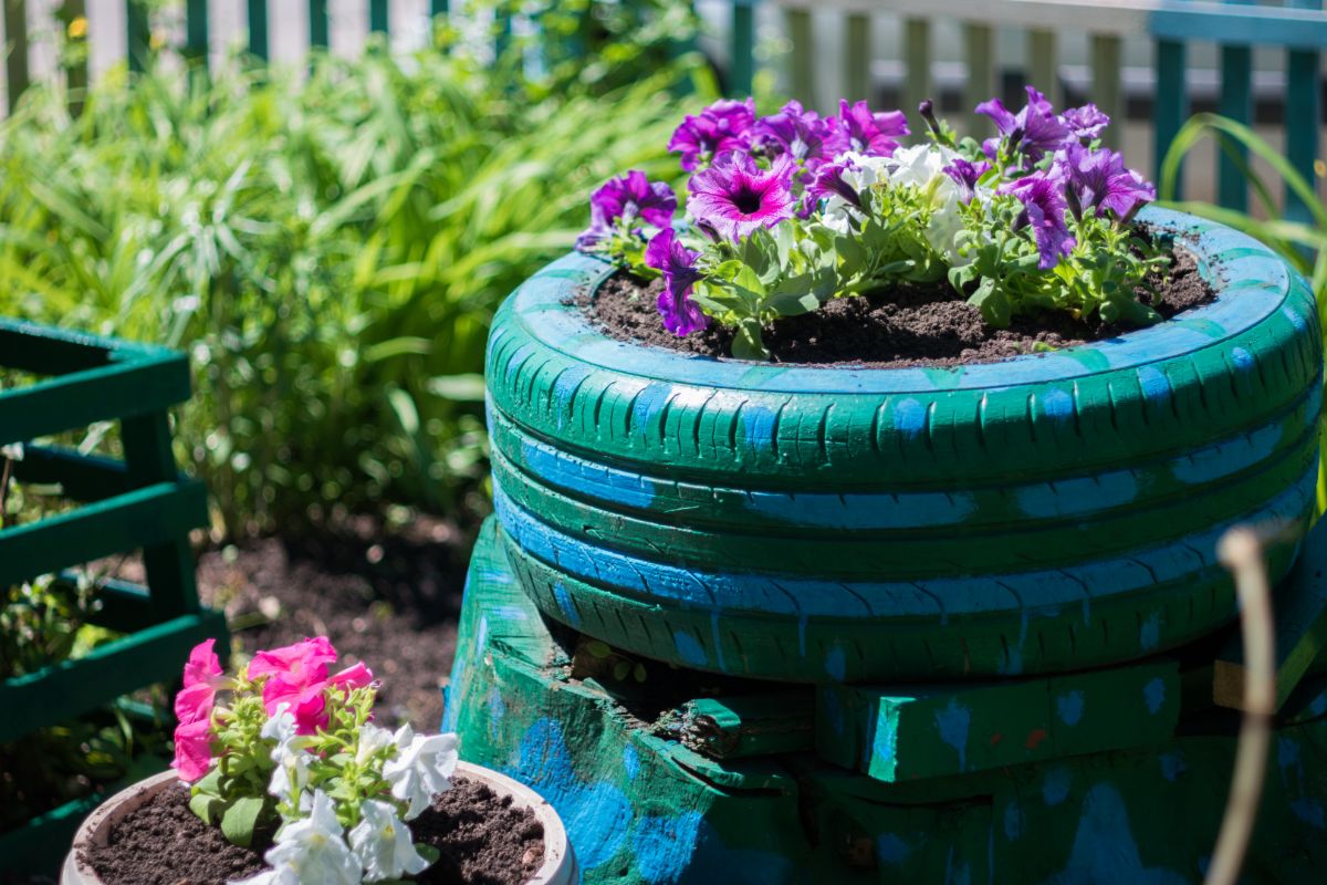 Old, upcycled, painted tires planted with ornamental flowers