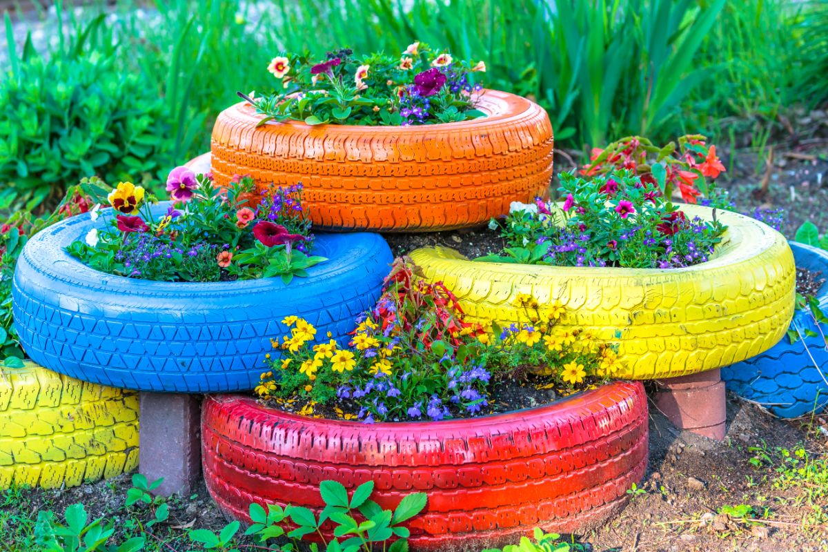 Tires painted different colors and stacked in a pyramid raised bed