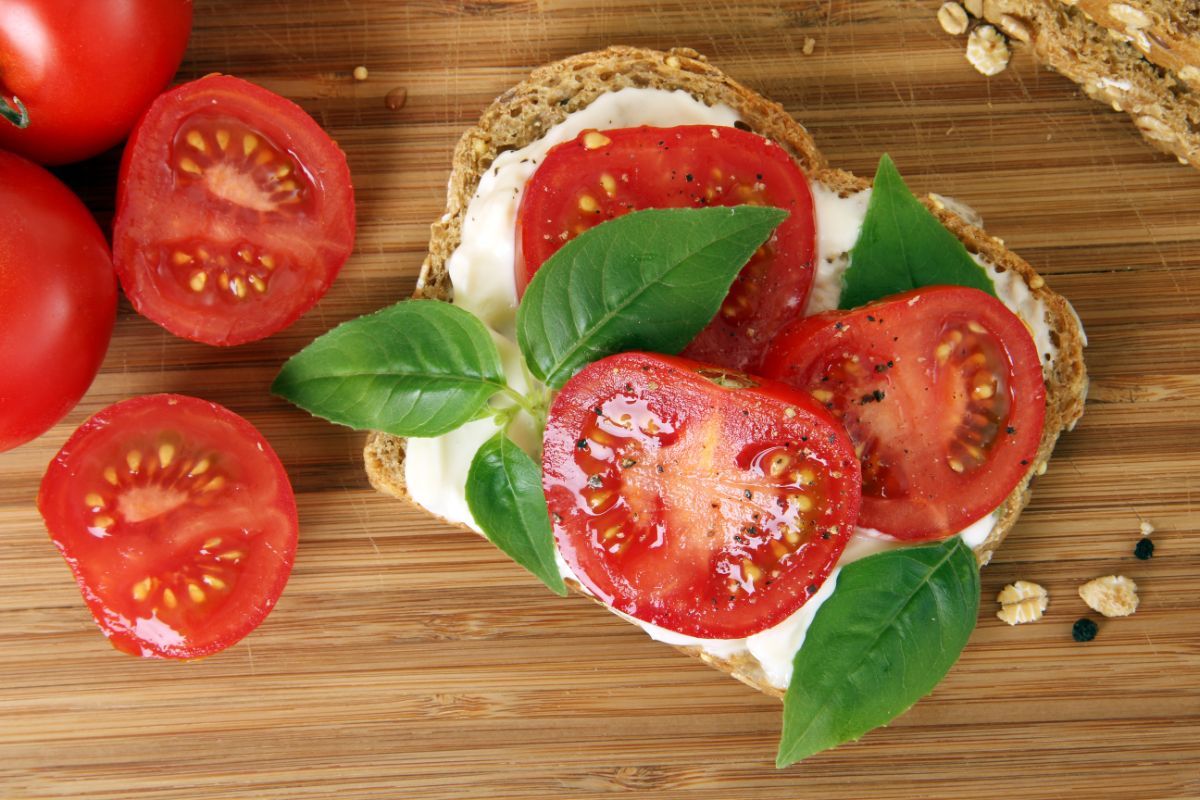 Deep red fresh tomatoes sliced on a sandwich