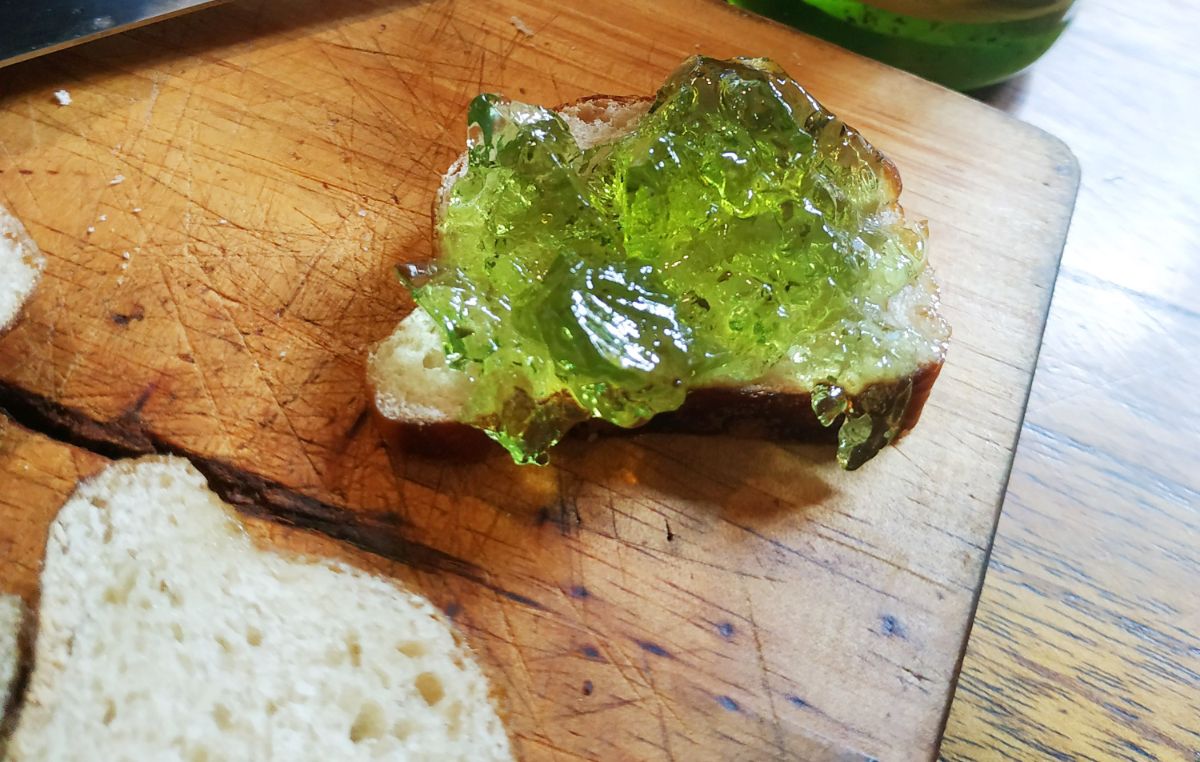 A dollop of green spruce tip jelly on crostini