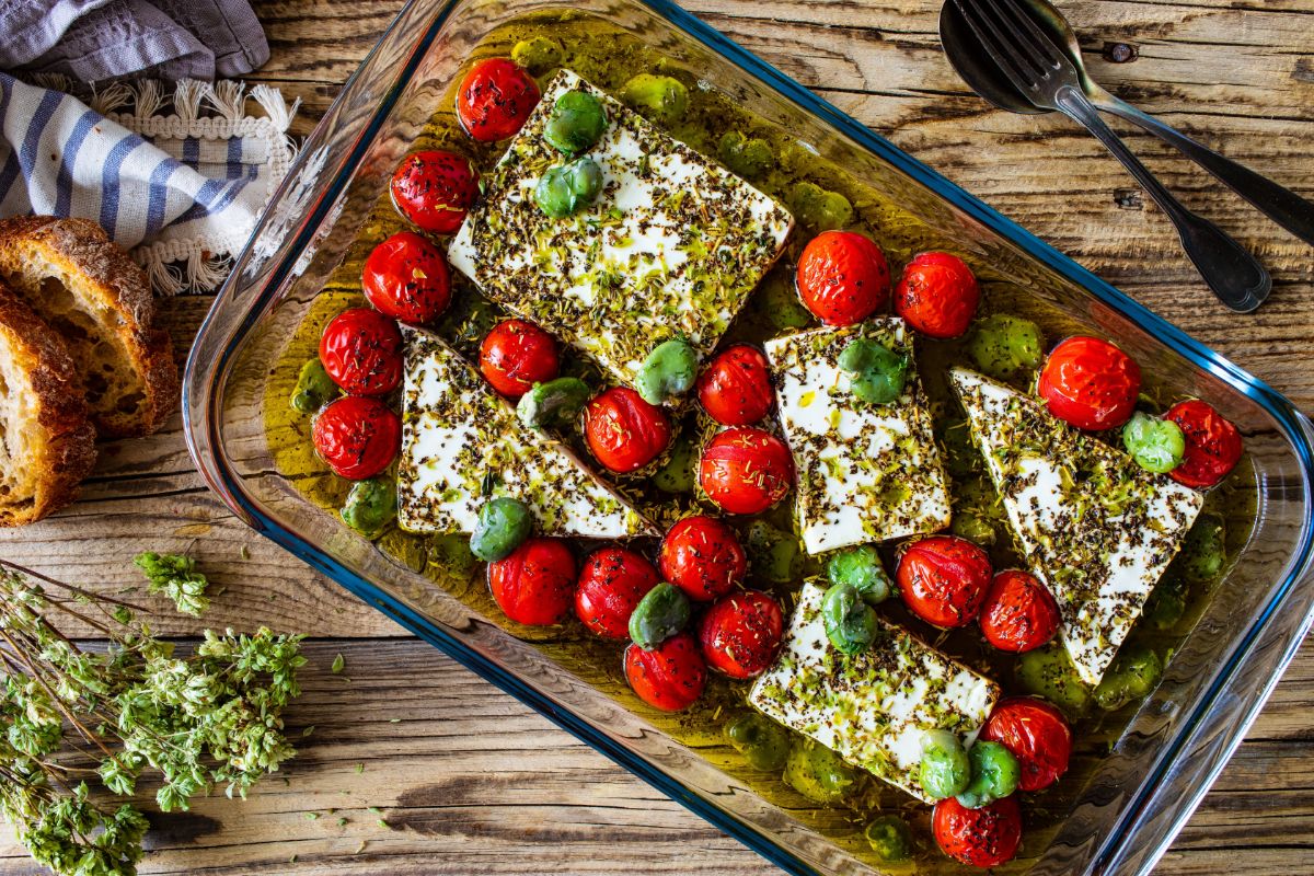 Roasted tomatoes in a cheese and oil dish