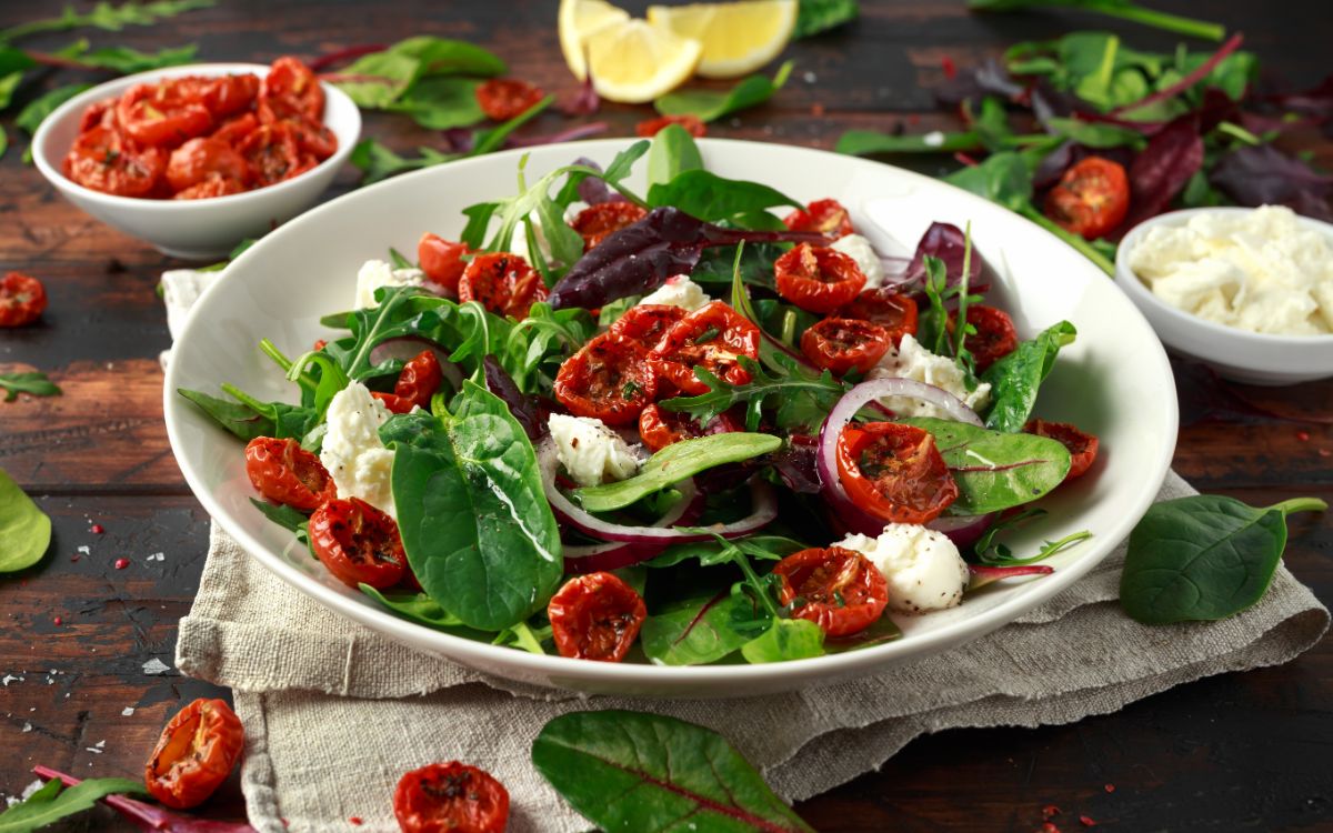 Sundried tomatoes soaked in oil over a fresh salad