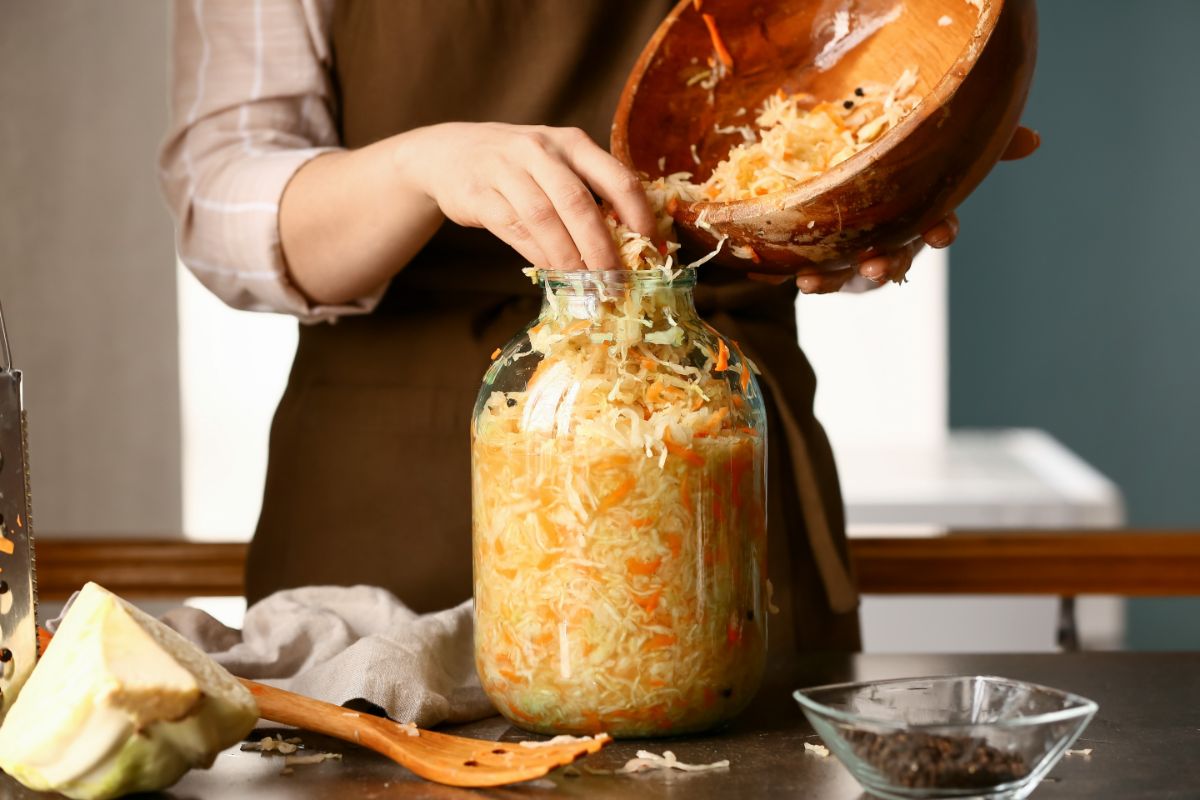 A woman preparing slaw for lacto-fermentation