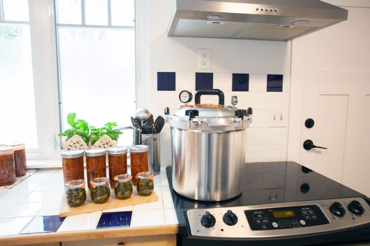 A pressure canner on a glass topped stove